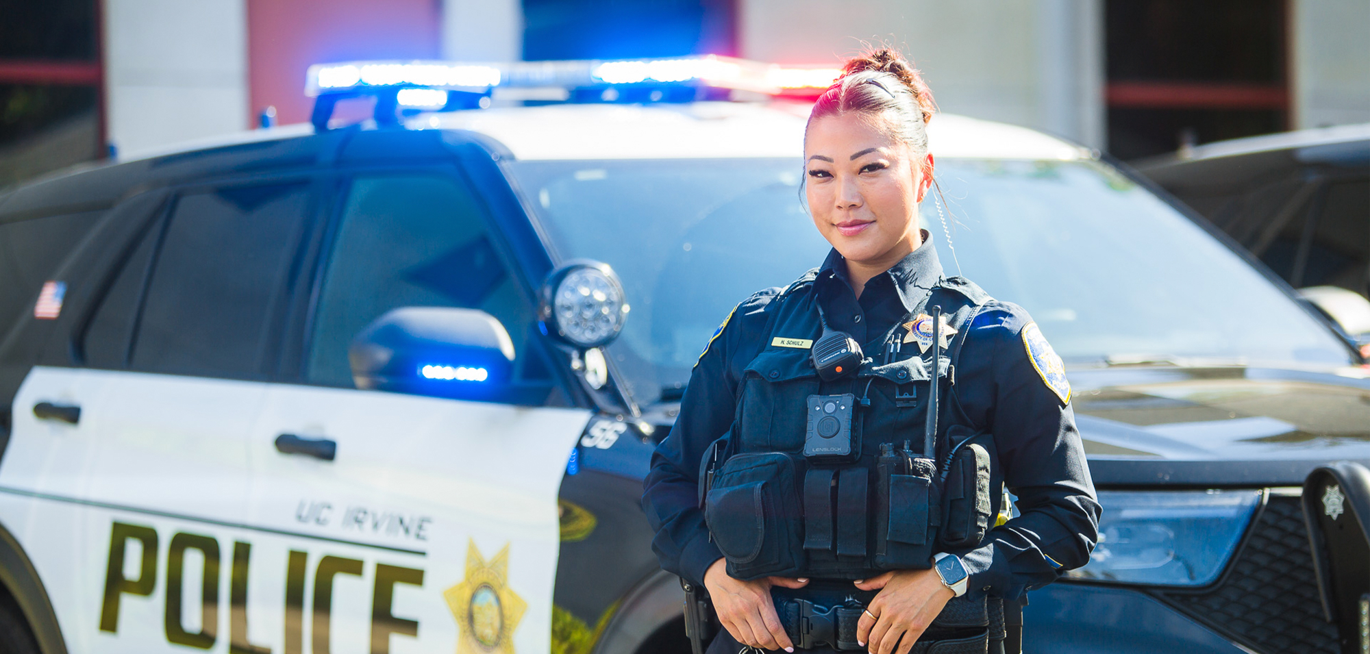 UC Irvine police officer standing in front of a vehicle