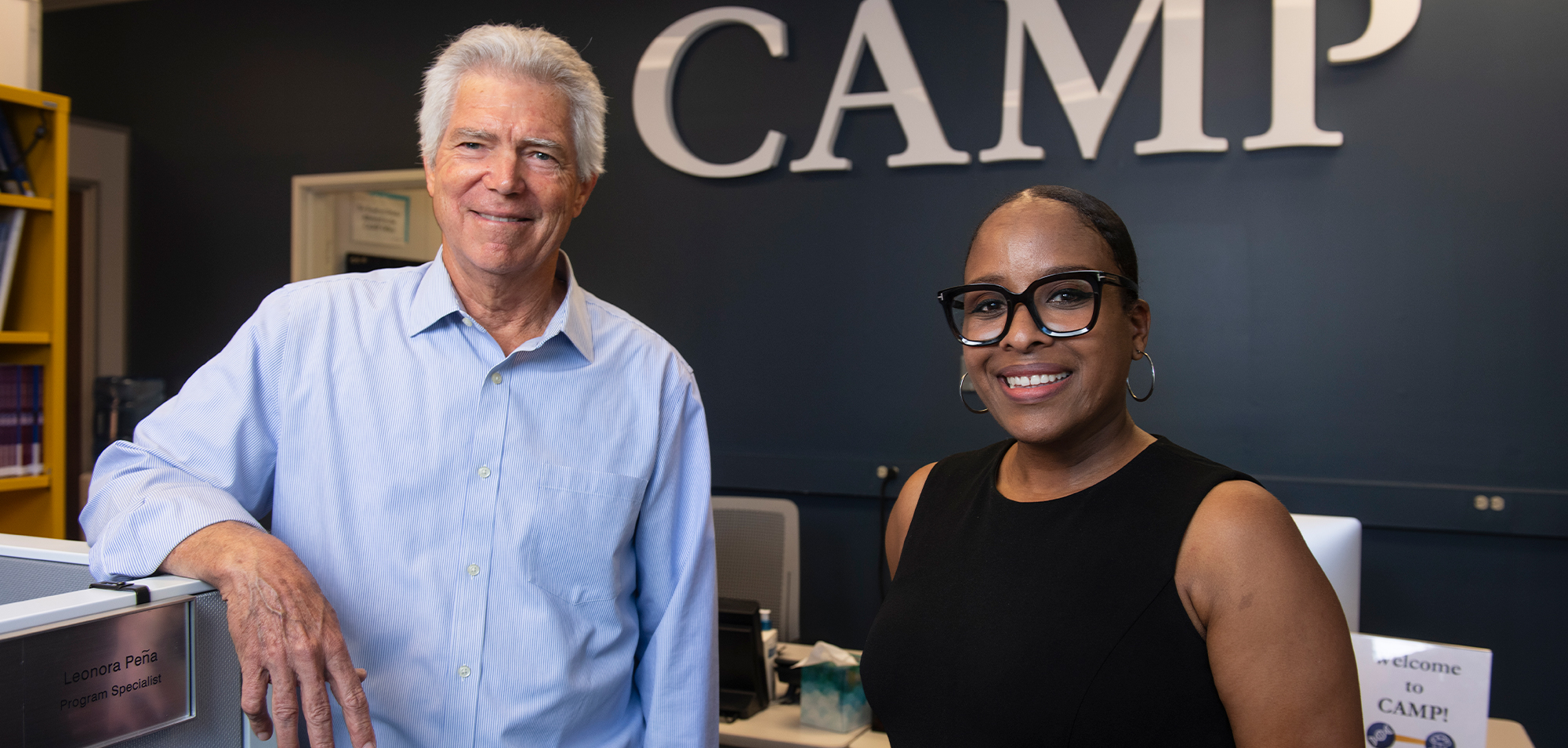two staff members standing next to each other